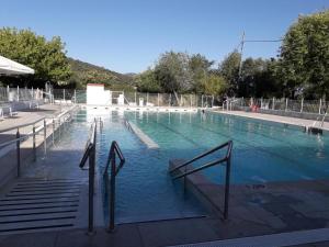 a large swimming pool with stairs in the water at Aires de Grazalema in Prado del Rey