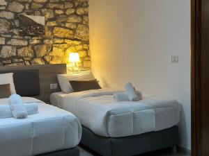 En eller flere senge i et værelse på Te Gjyshi