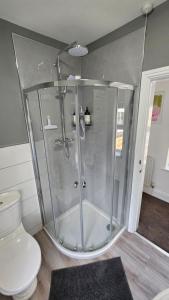 a shower stall in a bathroom with a toilet at Garden Cottage - Ashover Village near Matlock in Chesterfield +32 photos