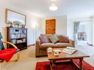 a living room with a couch and a coffee table at 1 Bed in Builth Wells BN029 in Llanafan-fawr