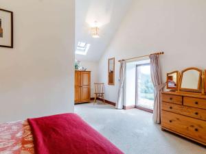 a bedroom with a bed and a dresser and a window at 1 Bed in Builth Wells BN029 in Llanafan-fawr