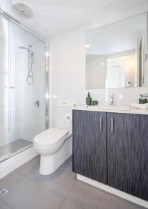 a bathroom with a toilet and a shower and a sink at Urban Retreat Townhouse near CBD in Perth