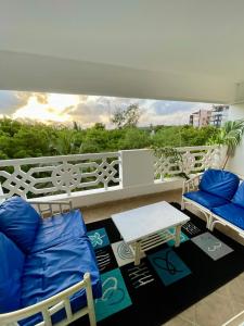 a balcony with two chairs and a table on a balcony at Sandy Shores-Nyali, Mombasa in Mombasa