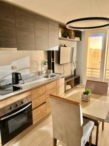 a kitchen with wooden cabinets and a table with a dining room at Apartamentos Concepción Centro in Concepción