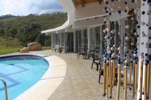 a house with a swimming pool and a patio at Casa Merak Villa Rural única en contacto con la naturaleza y tranquilidad in Oiba