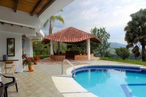 a swimming pool in front of a house at CASA MERAK - Inspira tu vida in Oiba