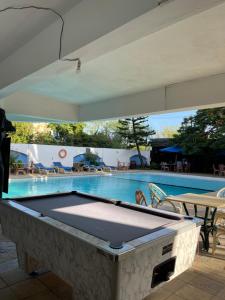 a pool table in front of a swimming pool at Sandy Shores-Nyali, Mombasa in Mombasa