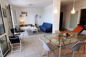 a living room with a glass table and chairs at Una prua sul mare in Nardò +36 photos