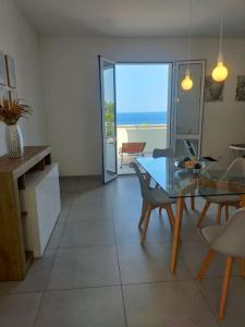 a living room with a glass table and chairs at Una prua sul mare in Nardò