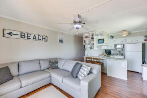 a living room with a couch and a kitchen at North Topsail Beach Condo with Ocean-View Balcony! in North Topsail Beach +20 photos