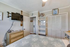 a bedroom with a bed and a flat screen tv at North Topsail Beach Condo with Ocean-View Balcony! in North Topsail Beach