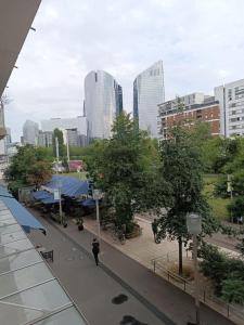 a person walking down a street in a city at PARIS La Défense Appt 3 Pièces in Nanterre