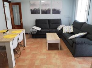 a living room with a couch and a table at Apartamento las huellas in Arnedillo