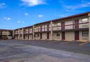 an empty parking lot in front of a building at Red Roof Inn Dallas - Richardson in Dallas