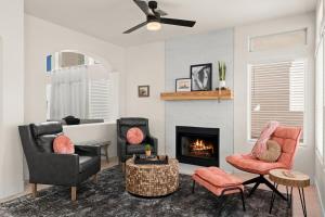 a living room with two chairs and a fireplace at Agave Cowboy in Phoenix