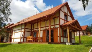 a small house with a roof at Domek A 151 Malinowy- Kaszubska Ostoja in Barkocin