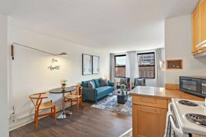 a kitchen and living room with a couch and a table at Inviting 2-Bedroom Apt in Hyde Park - The Blackwood 0404 in Chicago