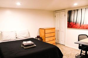 a bedroom with a black bed and a dresser at 1 Bed Apt - Amazing Location 1 Block to Carson St in Pittsburgh