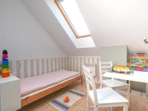 a room with a bed and a desk and chairs at Domek na Kaszubach A 152 Miętowy- Kaszubska Ostoja in Barkocin