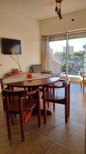 a dining room with a table and chairs and a television at Monte Grande Centrico-Aeropuerto in Monte Grande