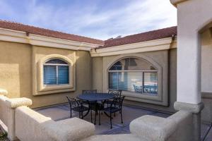 a patio with a table and chairs on a balcony at NEW Luxury Home Pool Spa Game Room Views in Lake Havasu City