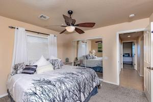 a bedroom with a bed and a ceiling fan at NEW Luxury Home Pool Spa Game Room Views in Lake Havasu City