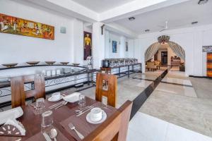 a kitchen and dining room with a table and chairs at The Richmond House Kandy in Kandy