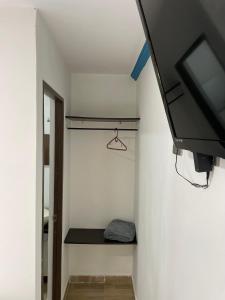 a small room with a tv and a closet at Habitación de descanso con aire acondicionado in Villavicencio