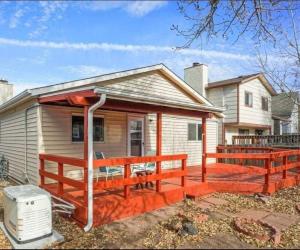 een huis met een groot terras ervoor bij Pet Friendly/3 King Beds/Mins to Airport in Colorado Springs