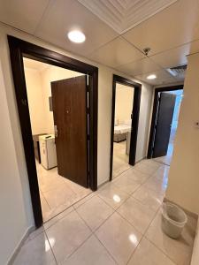 a hallway with doors and a room with a bedroom at ALBILAD ROYA HOTEL in Makkah
