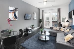 a living room with a couch and a table at Trifecta Luxury Serviced Apartment in Uptown CLT in Charlotte