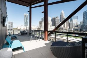 a balcony with a view of a city skyline at Trifecta Luxury Serviced Apartment in Uptown CLT in Charlotte