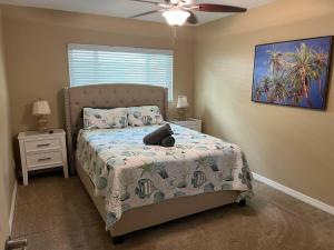 a bedroom with a bed and a ceiling fan at Tropical Pool & Patio Bar minutes to the beach! in Seminole