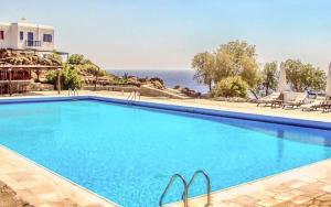 a swimming pool with a view of the ocean at PARIS HOUSE in Mikonos