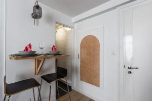 a dining room with a small table and chairs at Bright colorful apartment in the heart of Paris - Welkeys in Paris