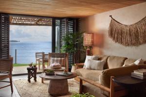 a living room with a couch and a view of the ocean at 1 Hotel Hanalei Bay in Princeville