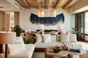 a living room with a white couch and a table at 1 Hotel Hanalei Bay in Princeville