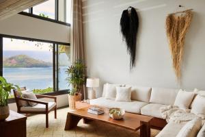 a living room with a white couch and a table at 1 Hotel Hanalei Bay in Princeville