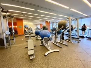 a gym with a row of treadmills and machines at 21st Floor Luxury Suite at Trump Int Resort in Miami Beach