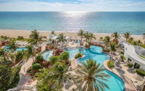 an aerial view of a resort with a swimming pool and the beach at 21st Floor Luxury Suite at Trump Int Resort in Miami Beach