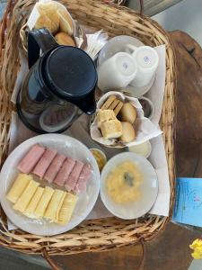 a basket filled with different types of bread and food at Jardim dos Milagres Suítes in São Miguel dos Milagres