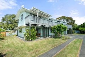 an exterior view of a house with a yard at Whole House Sleeps 12 AC -Wifi - Pool in Gisborne