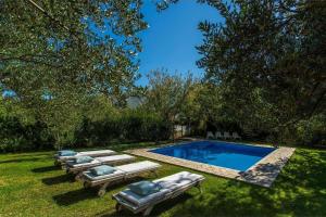 a row of loungers next to a swimming pool at Family friendly house with a swimming pool Klis, Split - 21656 in Klis