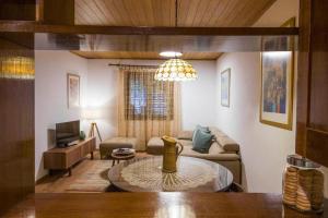 a living room with a couch and a table at Family friendly house with a swimming pool Klis, Split - 21656 in Klis