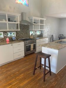a kitchen with white cabinets and a wooden floor at 311 Sunflower in Marble Falls