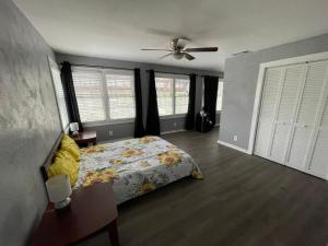 a bedroom with a bed and a ceiling fan at 311 Sunflower in Marble Falls