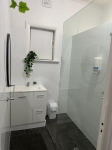 a white bathroom with a sink and a toilet at Minlaton Hotel in Minlaton
