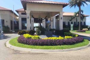 a house with a circular garden in front of it at Condominio Gold Coast 2BR 3BTH in Palm-Eagle Beach