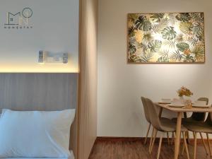 um quarto com uma cama e uma mesa com cadeiras em K Avenue Modern Style Studio (5 Mins to Airport) em Kota Kinabalu