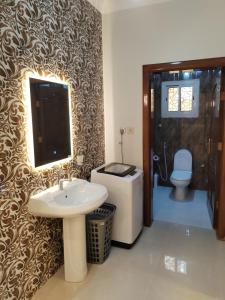 a bathroom with a sink and a toilet at شقق الياسمين in Medina +29 photos